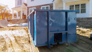 Blue dumpster in front of a house
