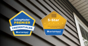A closeup of vinyl house siding with 2 professional badges added